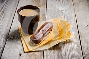 Cup of coffe with cake on thw rustic wooden background