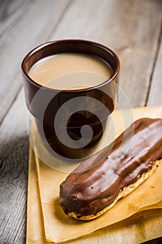 Cup of coffe with cake on thw rustic wooden background