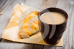 Cup of coffe with cake on thw rustic wooden background