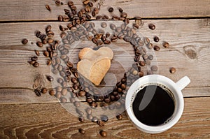 The cup of coffe and Frame- heart from coffee beans