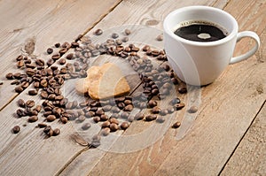 Cup of coffe and Frame-heart from coffee beans and two cookies-heart