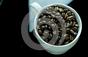 Cup of coffe full with beans