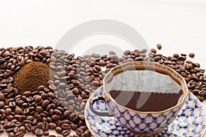 A cup of coffe and ground coffee