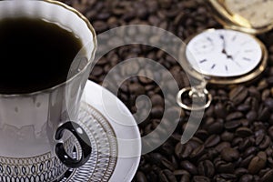 Cup of coffee against beans background closeup