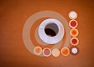 Cup of coffee and assortment of mixed biscuits