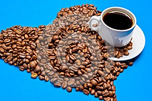 Cup with coffee on a background of coffee beans