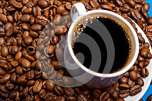 Cup with coffee on a background of coffee beans