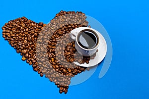 Cup with coffee on a background of coffee beans