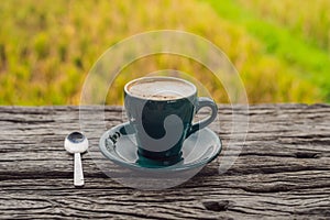 A cup of coffee on the background of an old wooden table
