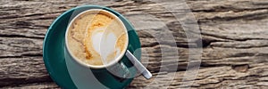 A cup of coffee on the background of an old wooden table BANNER, LONG FORMAT photo