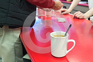 Cup of coffee on a bar table.