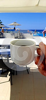 Cup of coffee on beach and relax.