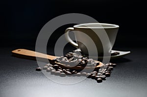 A cup with coffee bean on dark background