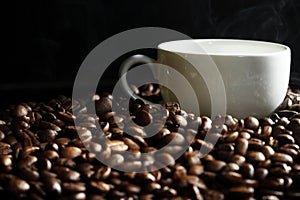 Cup of coffee on beans