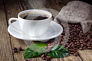 Cup of coffee, beans and leaf