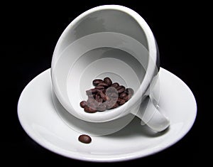 Cup of coffee beans on saucer