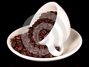 Cup of coffee beans on saucer