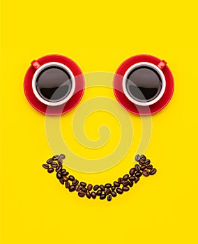 Cup of coffee and coffee beans with smile face concept, Top view on yellow background. For morning happy concept