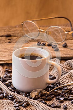 Cup of coffee with beans vintage still life