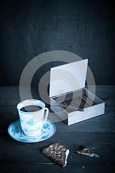 Cup of coffee, biscuits and a box of cigarettes