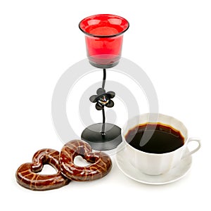 Cup with coffee, biscuits and a candlestick