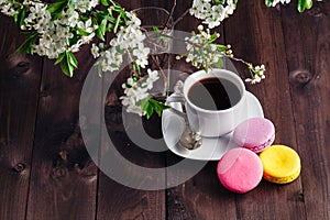 Cup of coffee and blooming twig of cherry tree