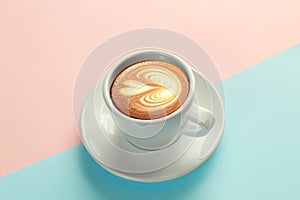 Cup of coffee on blue and orange background