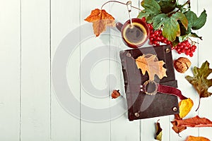 Cup coffee with book dry oaken leaf