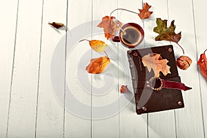 Cup coffee with book dry oaken leaf