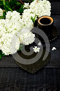 Cup of coffee with bouquet flower hydrangea and slate heart