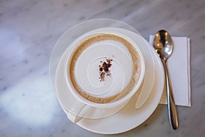 Cup of coffee capucino art on marble table