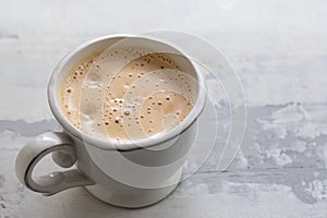 A cup of coffee on ceramic background