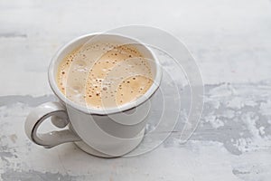 A cup of coffee on ceramic background