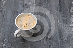 A cup of coffee on ceramic background