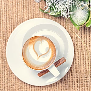 Cup of coffee or chai tea with latte art and Christmas decor. Le