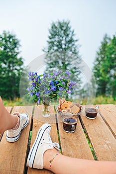 Cup of coffee on the chair over mountains landscape