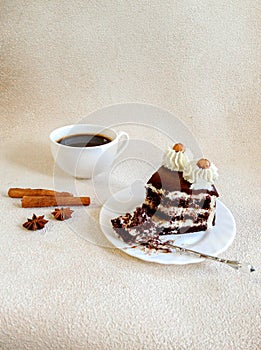 Cup of coffee, chocolate cake on beige background