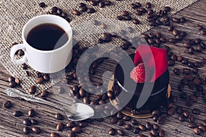 A cup of coffee with a chocolate cake with raspberries