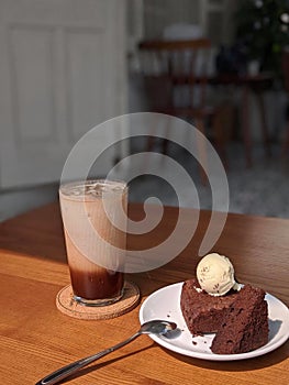 A cup of coffee and chocolate cake under sunshine