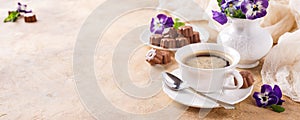 Cup of coffee with chocolate candies