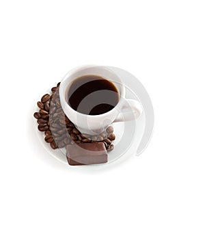 A cup of coffee, chocolate candy and seeds