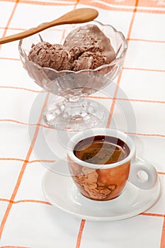 Cup of coffee and chocolate ice cream served on the table
