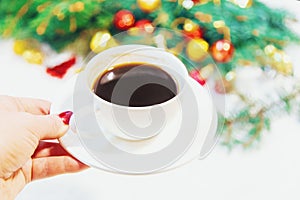 Cup of coffee on a christmas background. Christmas morning. Selective focus.