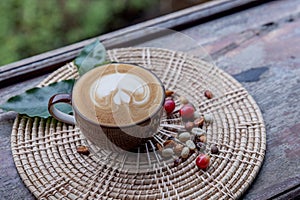 cup of coffee with coffee bean on the wood background