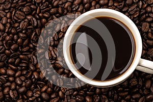 Cup of coffee with coffee beans  background