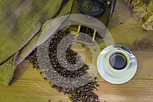 Cup of coffee, coffee-beans, coffee grinder, coffee sack