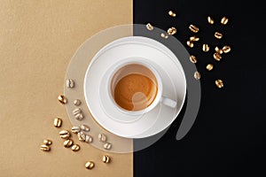 Cup of coffee and coffee beans on gold black background. Creative flat lay. Top view