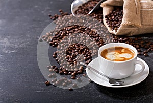 Cup of coffee and coffee beans in a sack