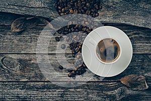 A cup of coffee and coffee beans on the table