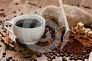Cup Of Coffee And Coffee Beans On Table.